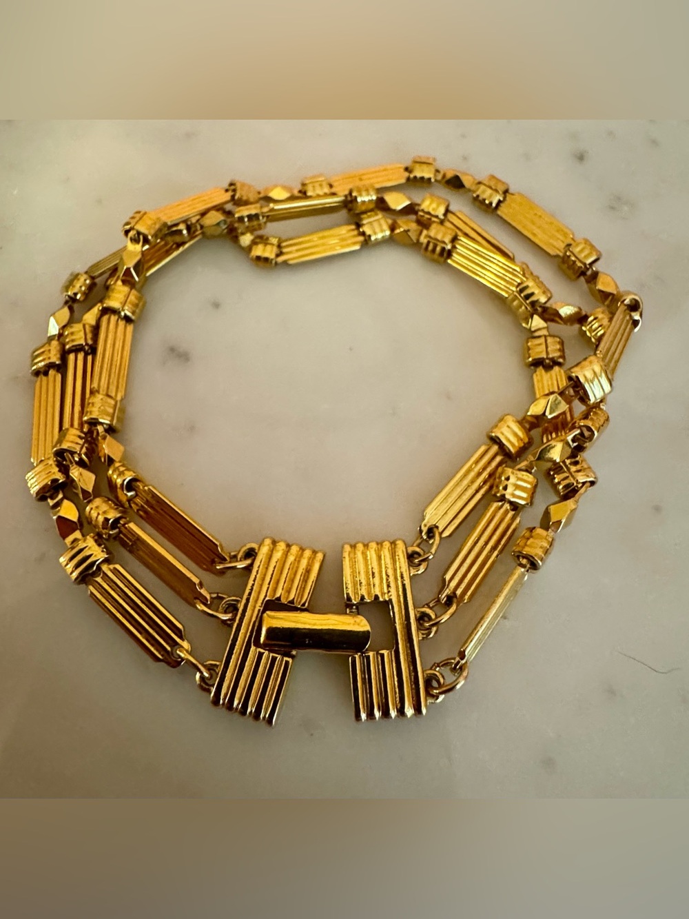 Gold Tone Triple Strand Station Bracelet with Geometric Details